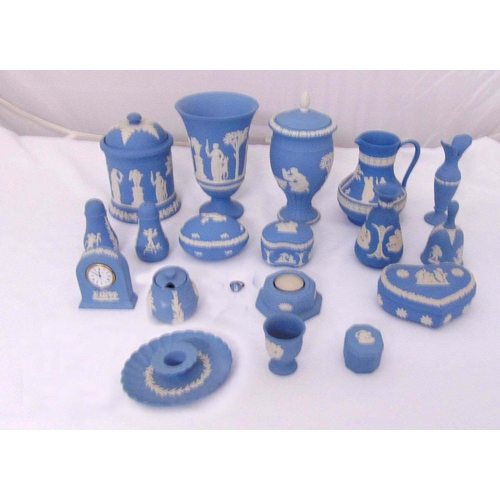 144 - A quantity of Wedgwood blue Jasperware to include vases, covered boxes, a clock, a table bell, a jug... 