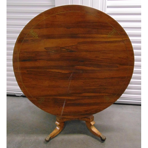 3 - A Regency brass inlaid circular tilt top dining table on four outswept scroll supports with original... 