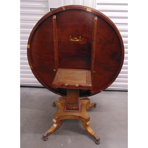 3 - A Regency brass inlaid circular tilt top dining table on four outswept scroll supports with original... 