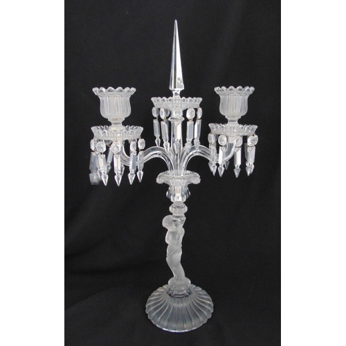 123 - A Baccarat two branch candelabrum, the figural stem supporting two scrolling arms with faceted drop ... 