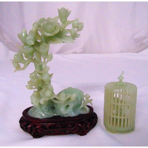 160 - A carved Chinese hardstone floral figurine on hardwood stand and a carved hardstone bird in a cage, ... 