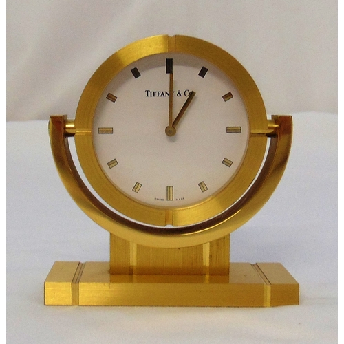 237 - Tiffany and Co. gilt metal desk clock, circular form, white enamel dial on rectangular plinth, seria... 