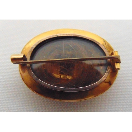 263 - A late Victorian mourning brooch set with a ruby and seed pearls