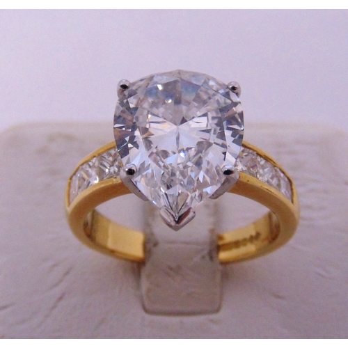 266 - 18ct yellow gold and diamond ring set with a pear shaped diamond approx 4 carats and six princess cu... 
