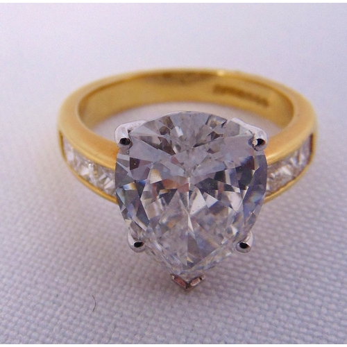 266 - 18ct yellow gold and diamond ring set with a pear shaped diamond approx 4 carats and six princess cu... 
