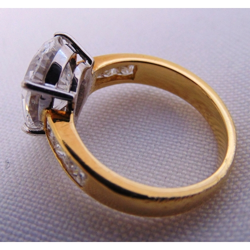 266 - 18ct yellow gold and diamond ring set with a pear shaped diamond approx 4 carats and six princess cu... 