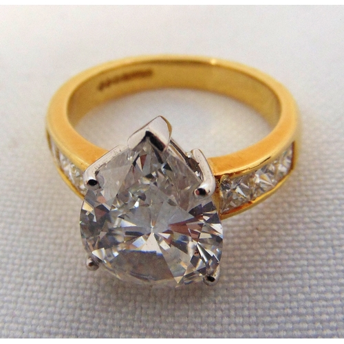 266 - 18ct yellow gold and diamond ring set with a pear shaped diamond approx 4 carats and six princess cu... 