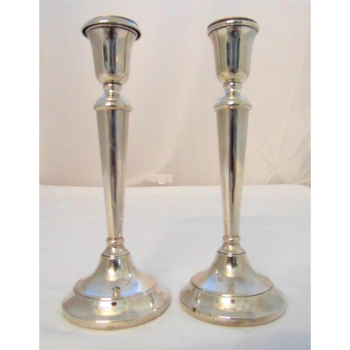 300 - A pair of hallmarked silver table candlesticks, tapering cylindrical on raised circular bases, Birmi... 