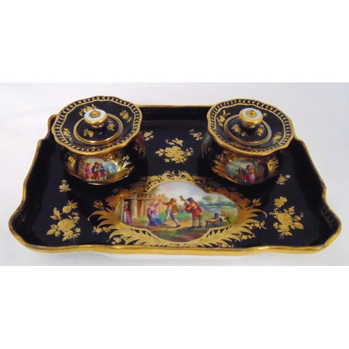 100 - A Meissen desk stand of shaped rectangular form decorated with courtly scenes and floral sprays, two... 