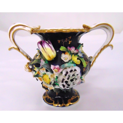 102 - A continental two handled vase with applied floral decoration, 10.5cm (h)