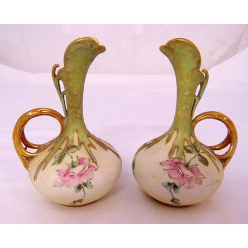 103 - A pair of Austrian decorative jugs with gilded handles and floral painted detail, marks to the bases... 
