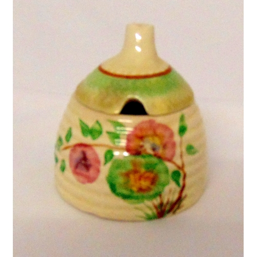 110 - Clarice Cliff honey pot and cover decorated with flowers and leaves, marks to the base, 8cm (h)