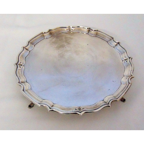 380 - A hallmarked silver salver with Chippendale border on four pad feet, Birmingham 1931, 27.5cm (d), ap... 