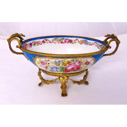 117 - A continental porcelain and gilt metal shaped oval table centrepiece with double scroll side handles... 