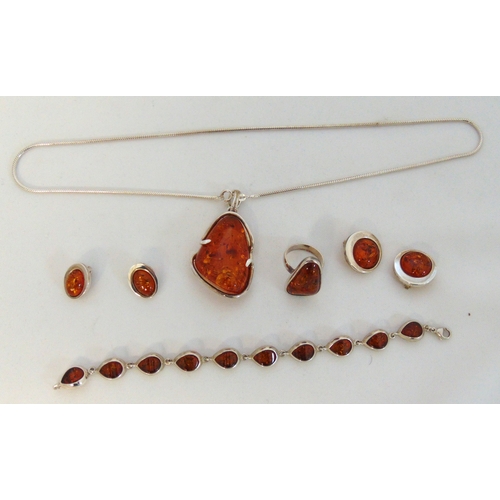 274 - A quantity of Amber jewellery to include a pendant on a chain, a bracelet, a ring and two pairs of e... 