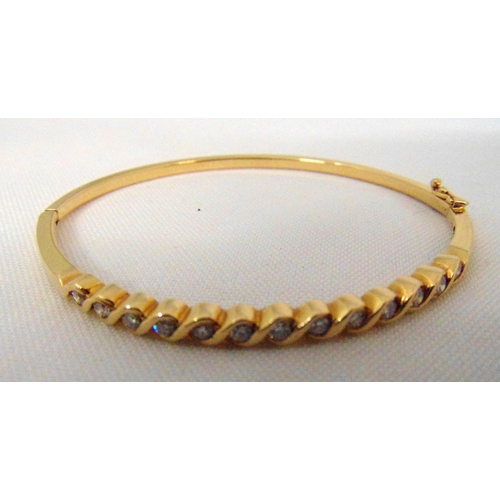 279 - 14ct yellow gold and diamond bangle set with thirteen diamonds, approx total weight 9.4g