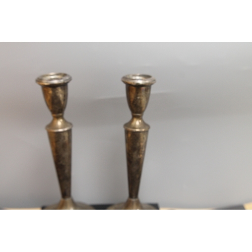 242 - Reed & Barton Sterling silver weighted and reinforced candlesticks,one A/F weight 582 gms