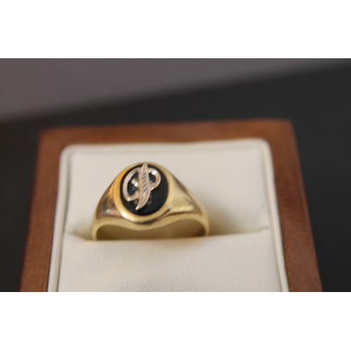 260 - Marked 750 gold ring with the letter P on black stone size S weight 2.8 gms