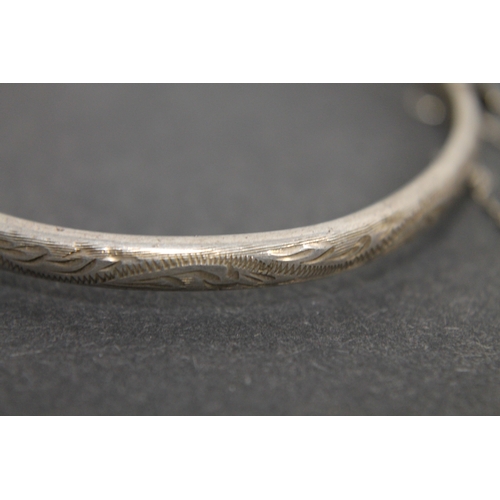 297 - Hallmarked silver engraved bangle with clasp and chain