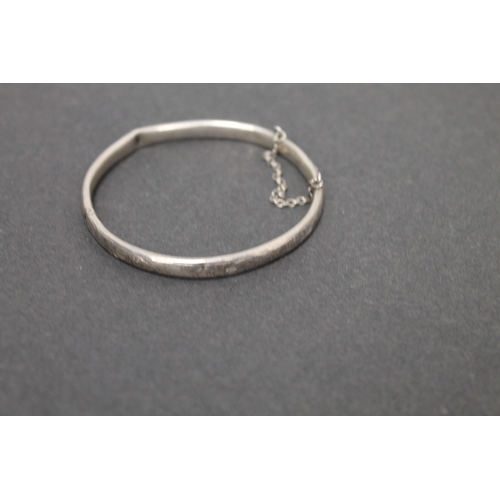 298 - Hallmarked silver engraved Charles Horner bangle with clasp and chain