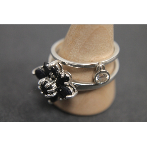 304 - 925 silver black stone flower ring size U and a 925 silver band ring with clear stone size R