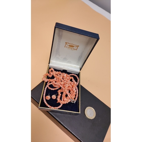 615 - 2 x coral bead necklaces and earrings set in original box, featuring intricately carved floral desig... 