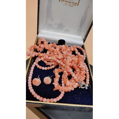 615 - 2 x coral bead necklaces and earrings set in original box, featuring intricately carved floral desig... 