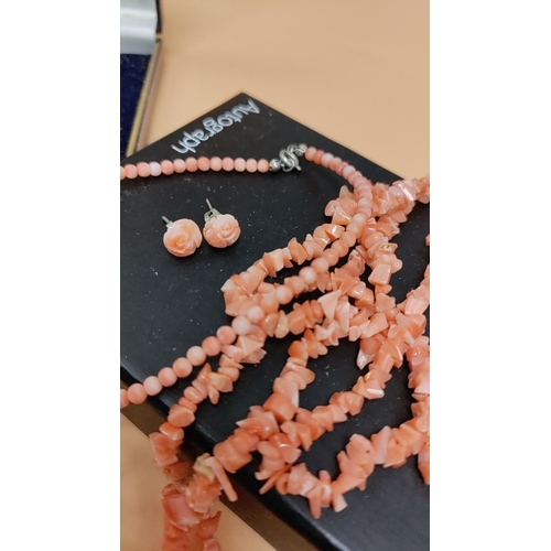 615 - 2 x coral bead necklaces and earrings set in original box, featuring intricately carved floral desig... 