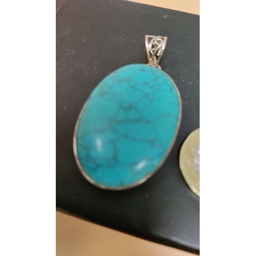 619 - Sterling silver pendant with turquoise gemstone, stamped with "925" hallmark.