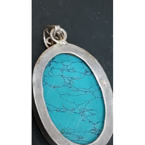 619 - Sterling silver pendant with turquoise gemstone, stamped with "925" hallmark.