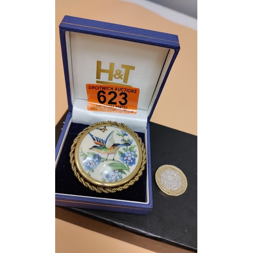 623 - LIMOGES France hand-painted enamel brooch features a colourful bird among blue floral motifs, encase... 