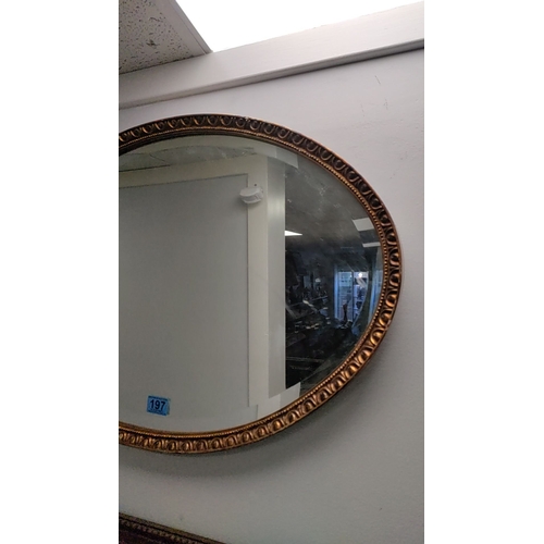 197 - Oval gilt resin framed bevel edged mirror 50cm x 72cm