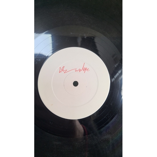 322 - Vinyl record features a white label with indescribable unknown artist  red text, song is Love Trap T... 