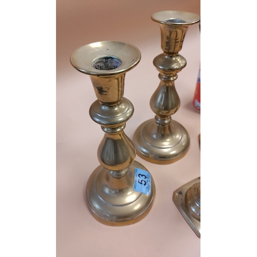 53 - Two pairs of brass candlesticks