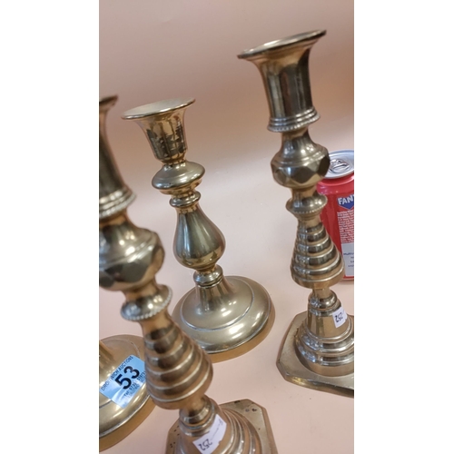 53 - Two pairs of brass candlesticks