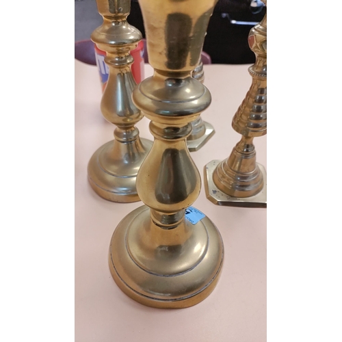 53 - Two pairs of brass candlesticks