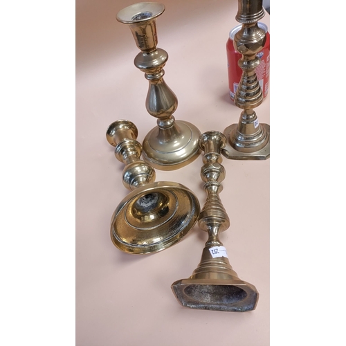 53 - Two pairs of brass candlesticks