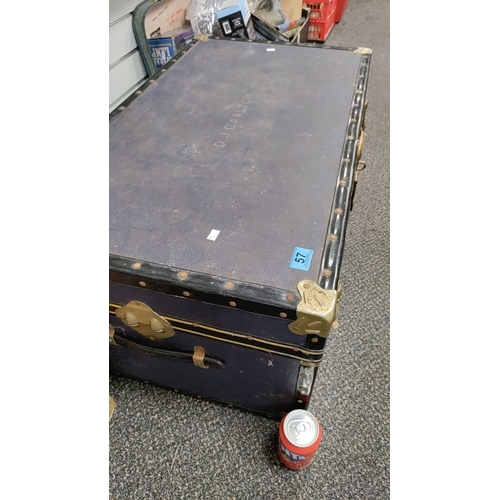 57 - Large blue vintage trunk with studded trim and brass finishing with D.J.Carlton name on top. H 36cm ... 