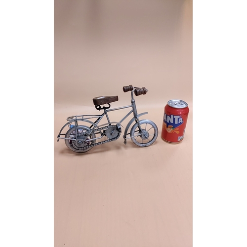 98 - Model tinplate bicycle, with chain and wooden saddle