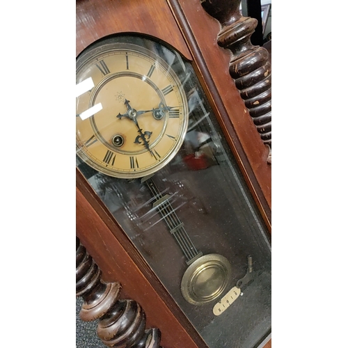 223 - Wooden Wall Clock with key, brass Pendulum and ornate top detailing