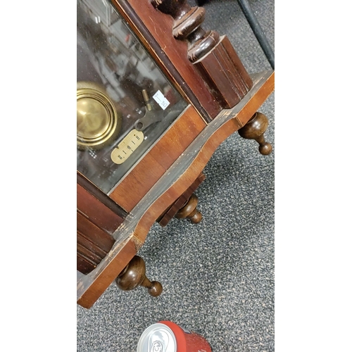 223 - Wooden Wall Clock with key, brass Pendulum and ornate top detailing