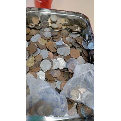 282 - Large tin of British coins and coins from around the world