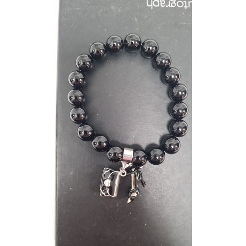 499 - Silver bracelet with black beads and a couple of charms 8cm across