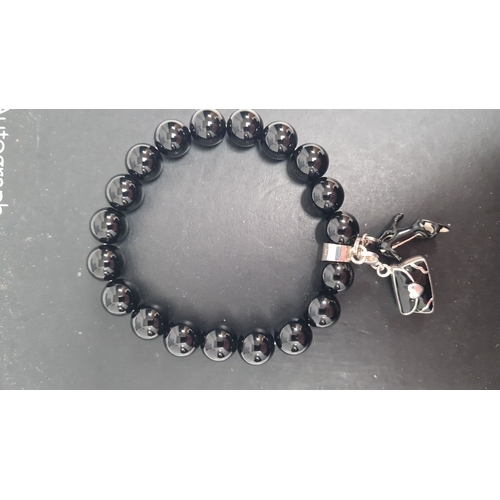 499 - Silver bracelet with black beads and a couple of charms 8cm across