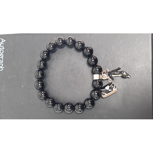 499 - Silver bracelet with black beads and a couple of charms 8cm across