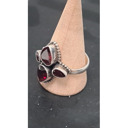 568 - 925 Silver ring with a dark red teardrop gemstone setting. Size U