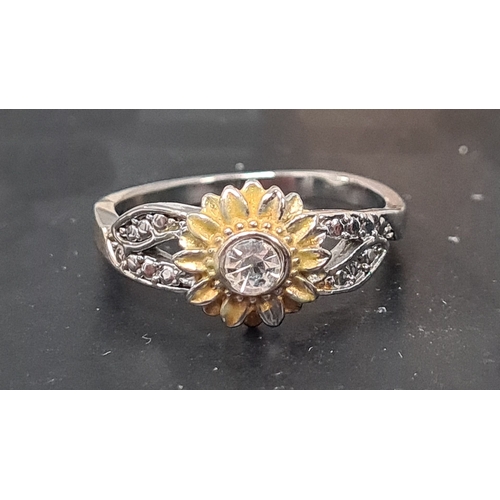 569 - 925 Silver ring with sunflower design and diamante setting. Size P