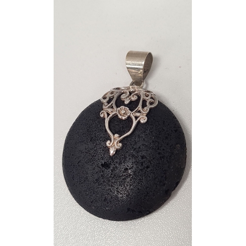 575 - Black lava style pendant with 925 Silver adornment. 3.5cm diameter