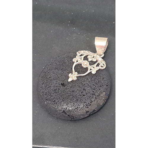 575 - Black lava style pendant with 925 Silver adornment. 3.5cm diameter