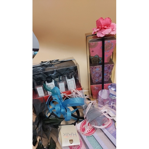 582 - Job lot of gift sets, hair fascinators, a crystal perfume bottle, pen set and nail file items